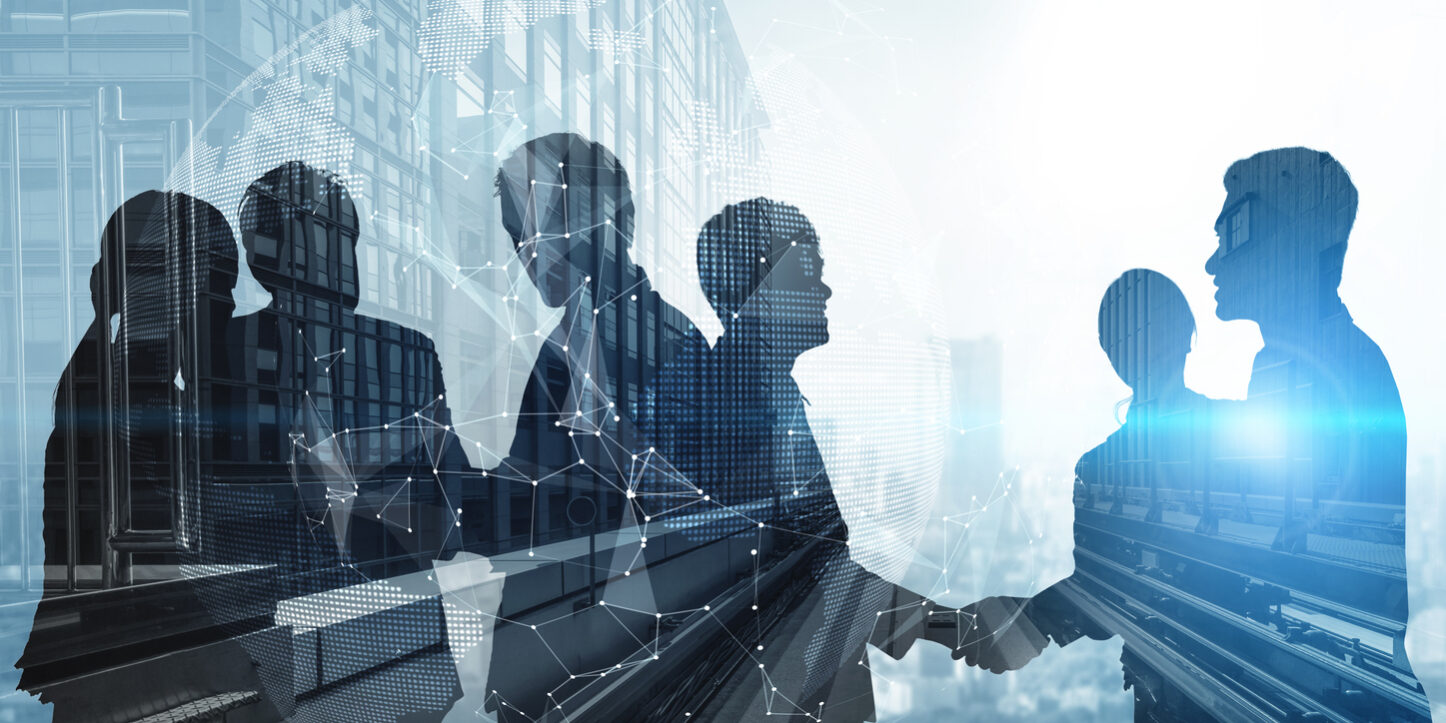 Launching Surge Silhouette view of business people team in group meeting on city office building background showing partnership success of business deal. Concept of teamwork, trust and agreement.