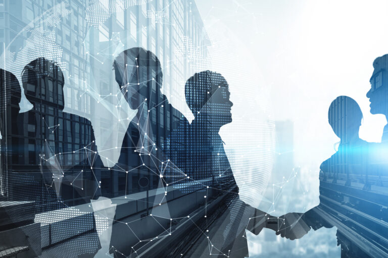 Silhouette view of business people team in group meeting on city office building background showing partnership success of business deal. Concept of teamwork, trust and agreement.